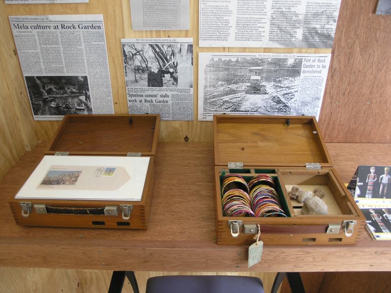 Press cuttings, and cases of collected bangles and stones