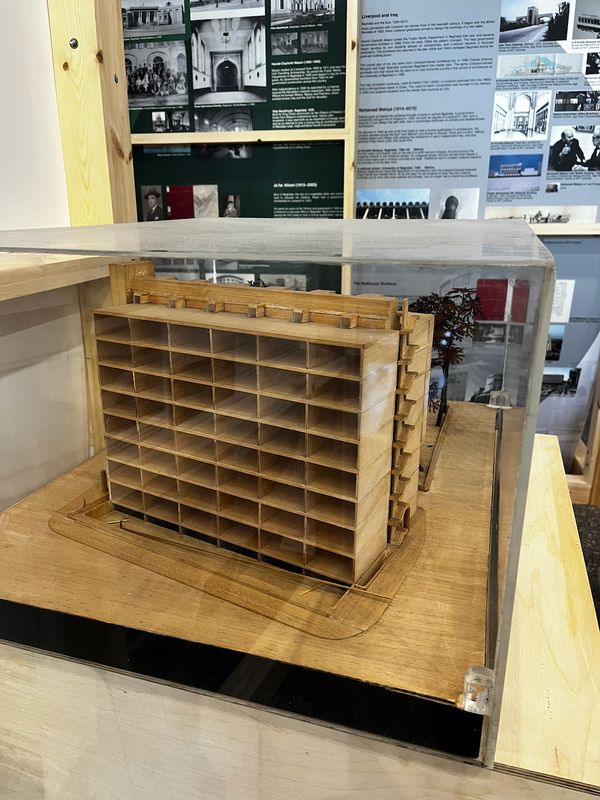 Model in a display case, with the Liverpool and Iraq panels behind